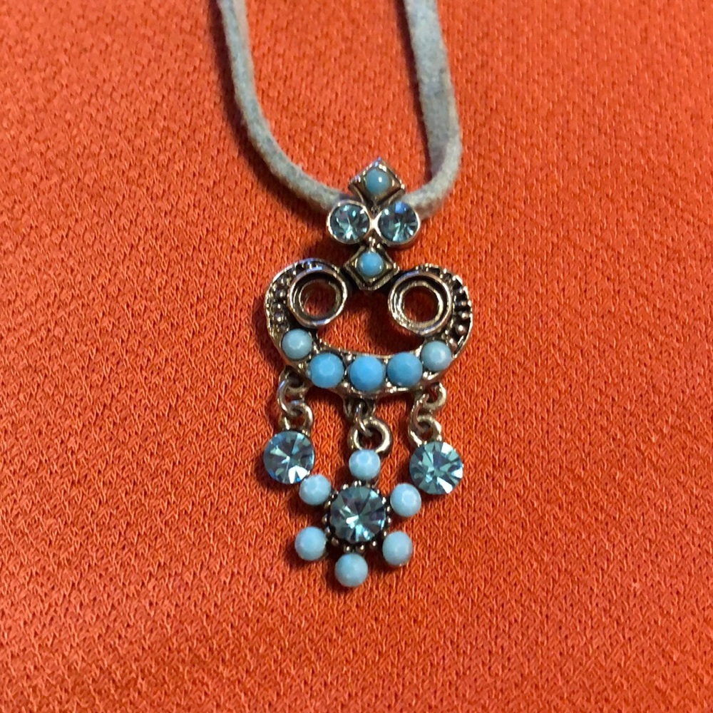 Pendant featuring blue stones and beads on a cord